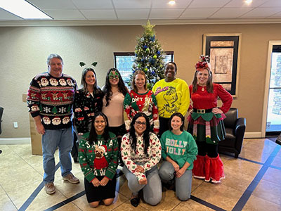 Some team members in the Ocala lobby at the 2023 Christmas party.